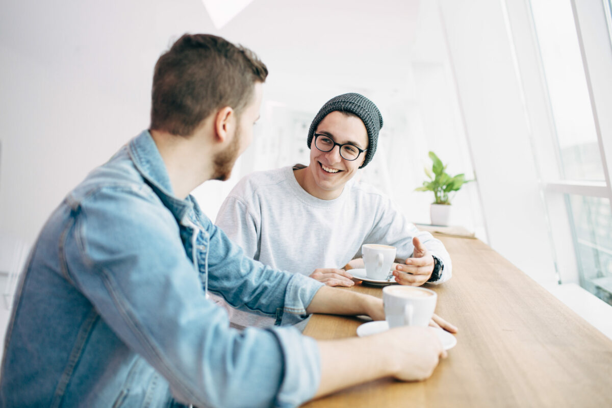 Two people having a conversation over coffee.
